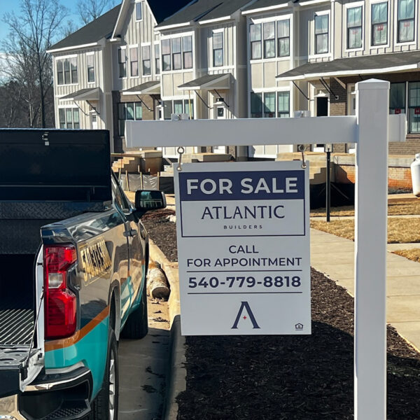 Atlantic Builders for-sale sign placed at a new townhouse community with call for appointment.