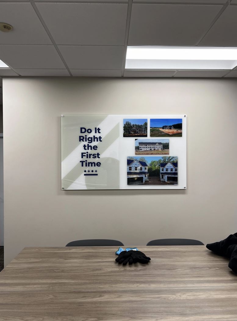 Photo of custom printed acrylic wall sign affixed with standoffs on office wall. Sign was designed, manufactured & installed by Distinct Sign Solutions in Fredericksburg, VA