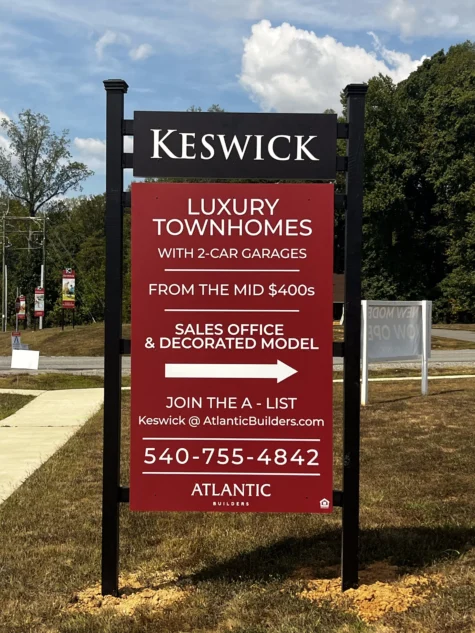 Photo of black and red custom home builder sign in grassy area in Spotsylvania, VA. Sign was manufactured & installed for Atlantic Builders by Distinct Sign Solutions in Fredericksburg, VA