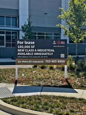 Photo of large post & panel sign affixed to white posts in grassy area. Sign is displaying FOR LEASE for JLL Mid Atlantic in Gaithersburg, MD. Sign was manufactured & installed by Distinct Sign Solutions in Fredericksburg VA