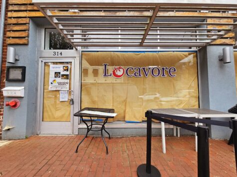 Photo of glass storefront adorned with purple & red tomato logo graphic for Locavore in Fredericksburg, VA. Graphic was manufactured & installed by Distinct Sign Solutions in Fredericksburg, VA