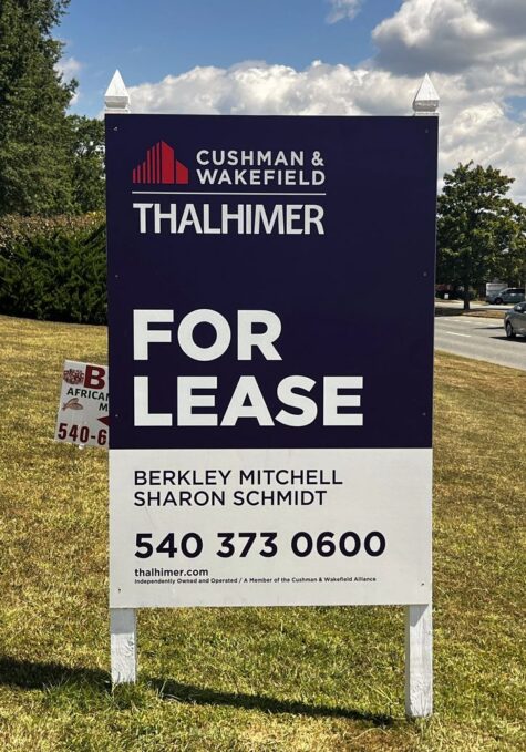 Photo of large post & panel sign affixed to white posts in grassy area. Sign is displaying FOR LEASE for Thahlimer, located in Stafford, VA. Sign was manufactured & installed by Distinct Sign Solutions in Fredericksburg VA