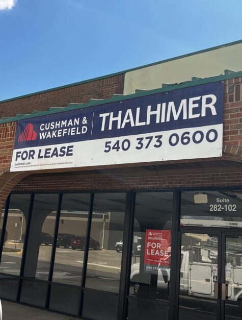 Photo of large banner sign affixed to brick wall in Stafford, VA. Banner was manufactured & installed by Distinct Sign Solutions in Fredericksburg VA