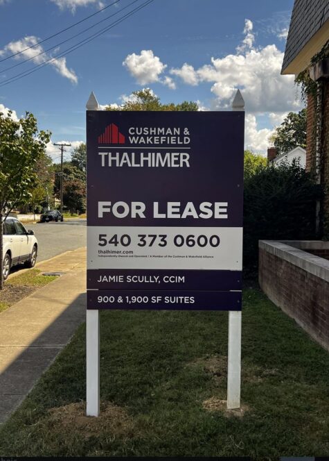 Photo of large post & panel sign affixed to white posts in grassy area. Sign is displaying FOR LEASE for Thahlimer Properties, located in Fredericksburg, VA. Sign was manufactured & installed by Distinct Sign Solutions in Fredericksburg VA